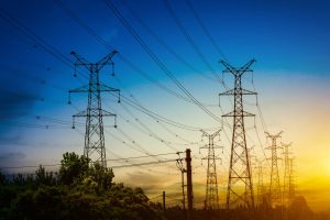 sun-setting-behind-the-silhouette-of-electricity-pylons